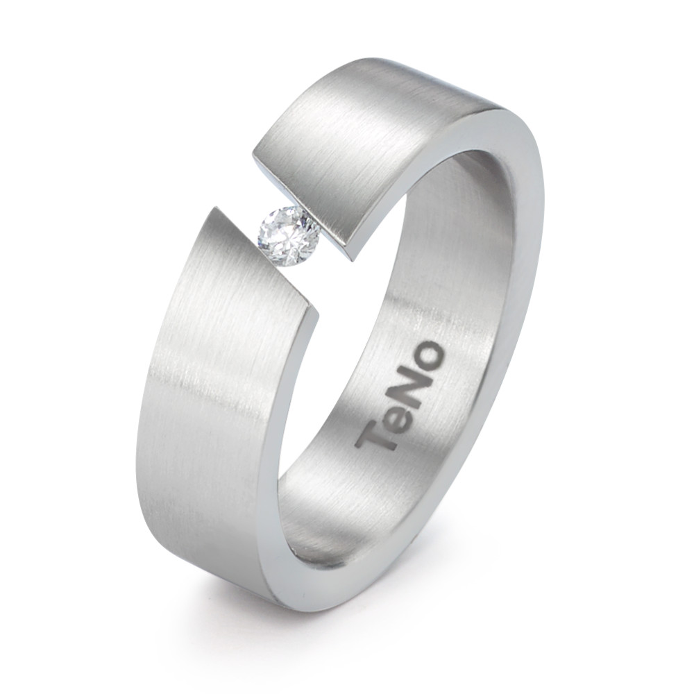 Fingerring Dieser markante Fingerring von TeNo aus Edelstahl vereint moderne Ästhetik mit raffinierten Details. Die mattierte Oberfläche unterstreicht das klare Design, während der funkelnde Diamant in der offenen Ringschiene scheinbar zu schweben scheint. Ein innovatives Schmuckstück, das Eleganz und Individualität verkörpert und sich perfekt für besondere Anlässe oder den Alltag eignet. 069.0237.XX