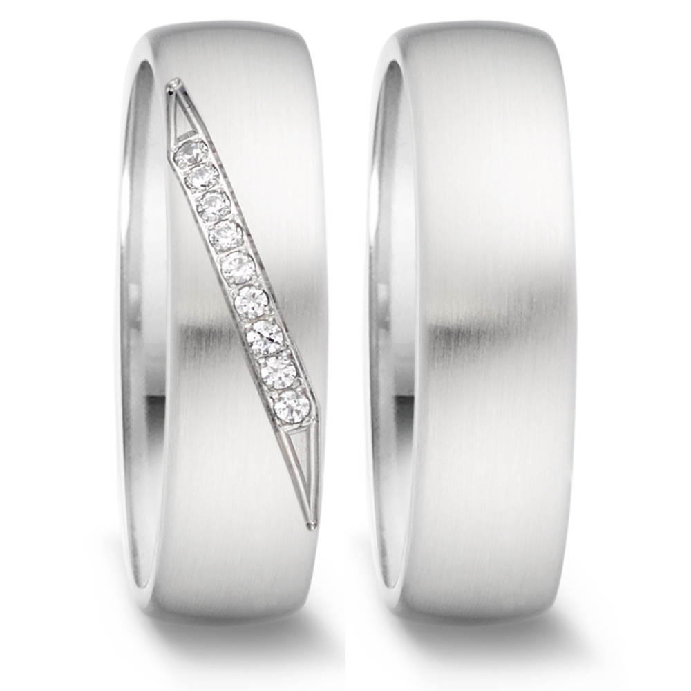 Partnerring Dieser elegante Partnerring für Damen von TeNo besteht aus hochwertigem Edelstahl und besticht durch seine matte Oberfläche und die bombierte Form, die sowohl innen als auch aussen für maximalen Tragekomfort sorgt. Eine Reihe funkelnder Diamanten verläuft diagonal über den Ring und verleiht ihm eine luxuriöse Note, ohne aufdringlich zu wirken. Der Ring ist sowohl stilvoll als auch robust, perfekt für Damen, die Eleganz und Beständigkeit suchen. 069.25P07.XX