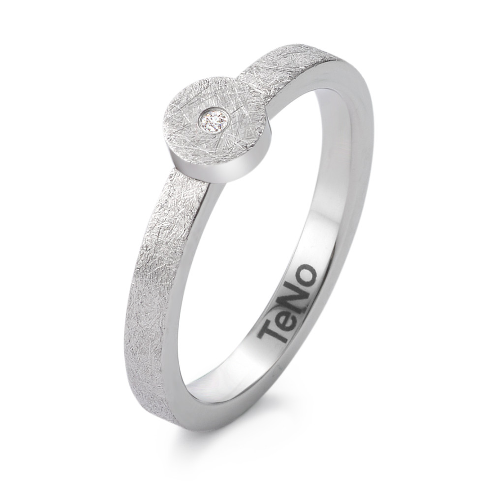 Fingerring Puristisch und markant: Dieser Ring aus eismattiertem Edelstahl von TeNo überzeugt mit klarer Formensprache und technischer Eleganz. Der kleine Diamant in der Mitte des kreisrunden Elements bringt feine Strahlkraft ins Design. Modern, langlebig und mit Liebe zum Detail gefertigt - ideal für alle, die minimalistischen Schmuck mit Charakter schätzen. Perfekt kombinierbar mit Anhänger und Ohrsteckern im selben Design.

 369.2413.XX